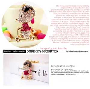Detail view of golden mouse on bicycle keychain with sparkling rhinestones and colorful oil drip