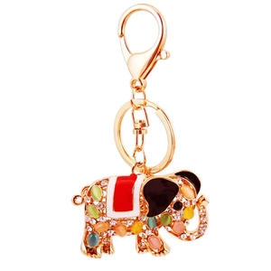 Golden elephant keychain with multicolored opal stones and crystal rhinestones on white background