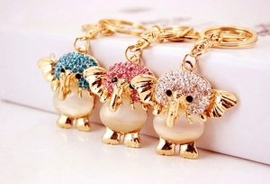 Macro detail of elephant keychains with cat eye stones and colorful crystals in gold finish