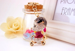 Detail of a sparkling rhinestone mouse riding a scooter keychain with premium gold lobster clasp