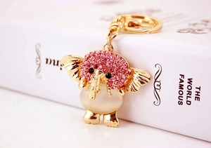 Detailed view of pink rhinestone elephant keychain with cat eye stone and golden hardware