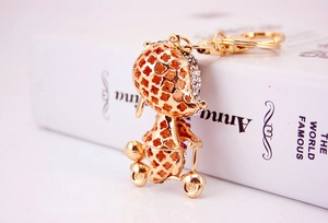 Detailed side view of golden scooter mouse keychain with sparkling crystals and clover pattern