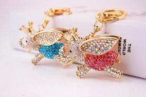 Detailed view of rhinestone elephant keychains with pink and blue crystals and golden base