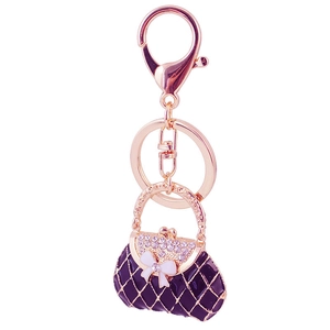 Sparkling rhinestone bow handbag keychain in purple enamel and rose gold plating