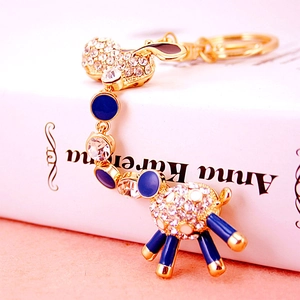 Sparkling lamb keychain with white rhinestones and blue enamel on a gold alloy base