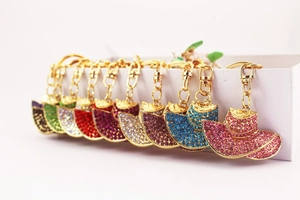 Detailed close-up of sun hat keychains with colorful rhinestones and gold lobster clasp