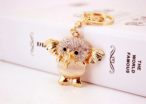 Detail of a gold elephant keychain featuring opal inlay and sparkling crystal rhinestones