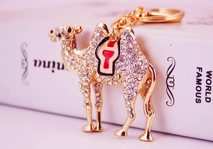 Detail of camel keychain with sparkling rhinestones and red enamel on gold metal