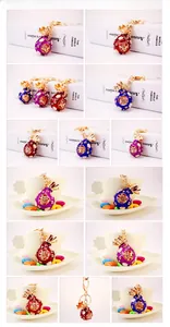 Macro details of lucky money bag keychains with rhinestones in purple, red, and blue colors