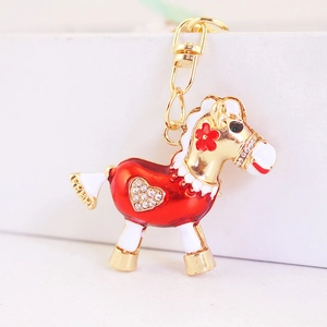 Porte-clés cheval à bascule avec strass brillants, métal doré et émail rouge élégant