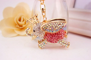Detailed view of flying elephant keychain with pink and white sparkling rhinestones
