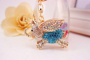 Macro shot of blue rhinestone elephant keychain with gold crown and sparkling crystal detail