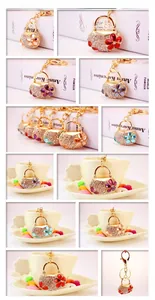 Macro detail of rhinestone-encrusted bag pendants and gold-plated alloy keychains