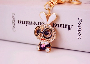 Close-up of cute cartoon rabbit keychain with gold metal plating and crystal rhinestones