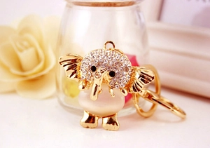 Close-up of golden elephant keychain with sparkling rhinestones and opal stone detail