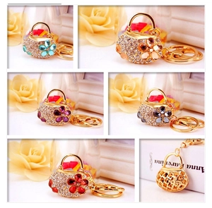 Macro detail of alloy handbag keychains featuring colorful rhinestones and floral accents