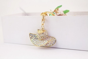 Close-up of golden cowboy hat keychain with colorful rhinestones and spring clasp