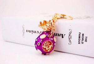 Close-up of a purple rhinestone money bag keychain with a gold Chinese lucky charm symbol