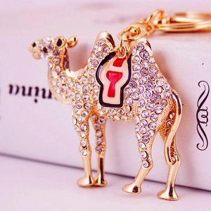 Creative camel keychain in gold metal with white rhinestones and enamel saddle detail