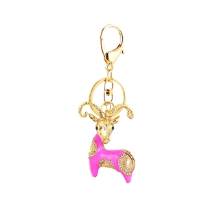 Charming golden goat keychain with pink enamel and sparkling rhinestones for handbags