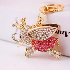 Charming gold elephant keychain with sparkling rhinestones, crown, and wings design