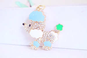 Nahaufnahme von Pudel-Schlüsselanhänger mit Diamanten, blauem Emaille und grüner Blume