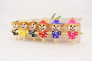 Macro detail of various colorful scarecrow keychain pendants with sparkling rhinestones