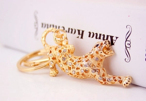 Close-up of golden leopard keychain with white rhinestones on Anna Karenina book