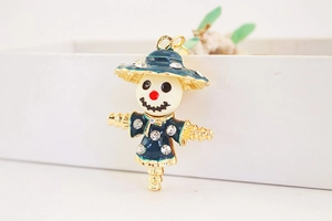 Macro detail of a green enamel scarecrow pendant with sparkling crystal rhinestones