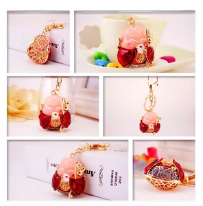 Detailed views of a creative Chinese longevity deity keychain with red enamel and gold filigree