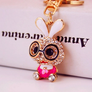 Cute bunny keychain with glasses and pink outfit, studded with sparkling white rhinestones