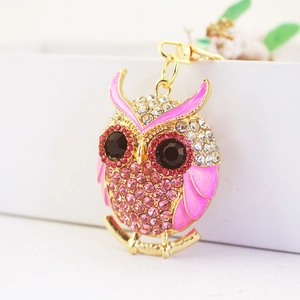 Pink owl keychain with sparkling rhinestones and gold-tone finish on a white gift box