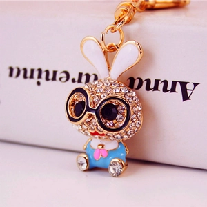 Cute cartoon rabbit keychain with sparkling white rhinestones and blue shirt details