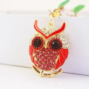 Creative cartoon owl keychain with red rhinestones and gold plating on a white background