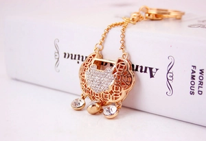 Detail of Chinese style gold longevity lock keychain with sparkling crystal rhinestones