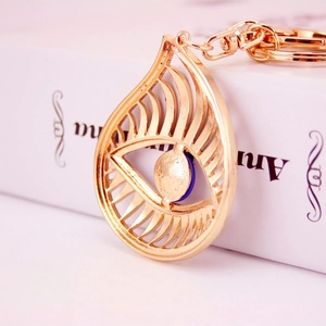 Golden Evil Eye keychain with blue crystal bead and sparkling rhinestones on water drop frame