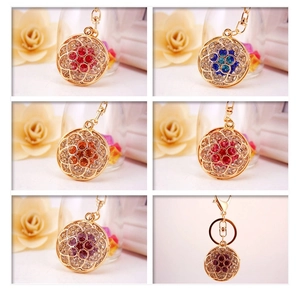 Detail showing colorful rhinestone inlaid floral keychains with golden metal finish