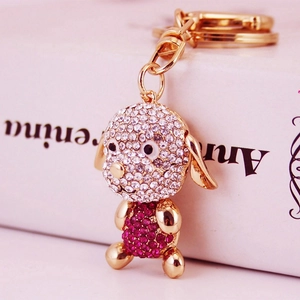Porte-clés chiot aux longues oreilles avec strass blancs et rose fuchsia sur base dorée
