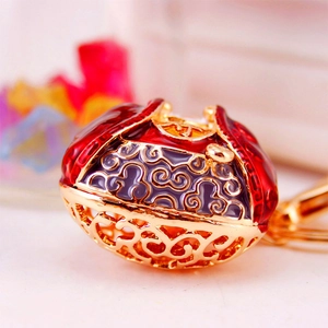 Chinese style Ruyi lock keychain with red enamel and golden hollow cloud patterns