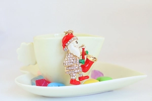 Detail of crystal rhinestone Santa Claus pendant hanging on a cup for gift ideas