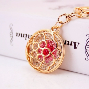 Elegant gold hollow flower keychain with sparkling gradient rhinestones for women's bags