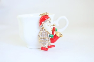 Detail of Santa Claus keychain with saxophone design and sparkling white rhinestones