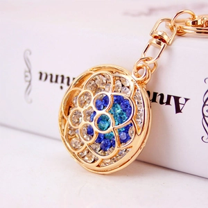 Exquisite gold metal hollow floral keychain with blue and white sparkling rhinestones