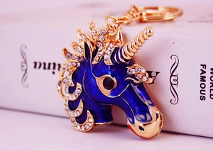 Macro shot of blue enamel unicorn keychain with sparkling crystal rhinestones and gold plating