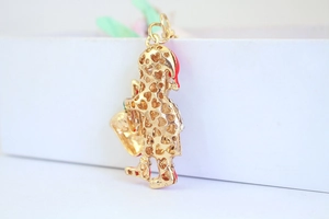 Detail of Santa Claus keychain with gold plating, hollow heart back and red enamel
