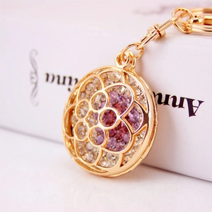 Elegant gold hollow flower keychain with pink and white rhinestones for women's handbag