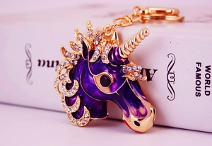 Detailed macro view of purple enamel unicorn keychain with sparkling white rhinestones