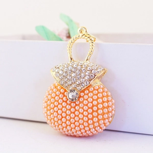 Sparkling rhinestone and pink pearl handbag-shaped keychain charm with golden hardware