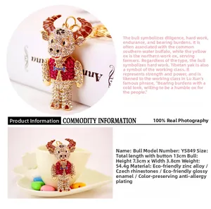 Detail view showing dimensions of a cute rhinestone cow keychain with gold plating