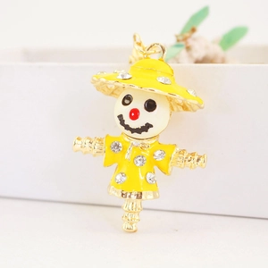 Cute yellow enamel scarecrow keychain with sparkling rhinestones and golden metal hardware